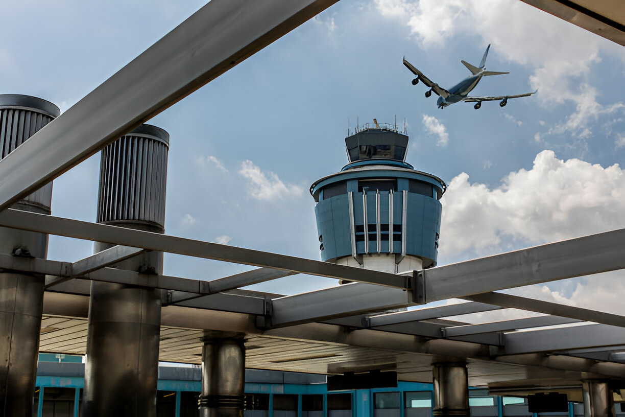 an airplane landing or taking off near the air traffic control tower at LaGuardia Airport (LGA) in New York City.