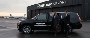 Professional Superstar Chauffeur holding the door of a black Cadillac Escalade SUV for an executive client on the tarmac at Republic Airport in Farmingdale, NY.